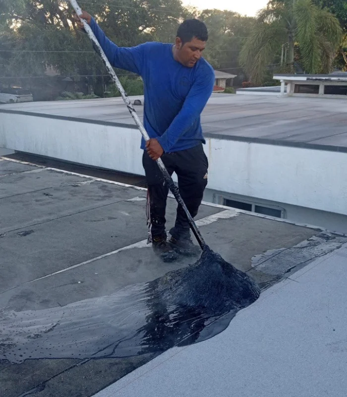 Century Roofing Specialist working on a flat roof