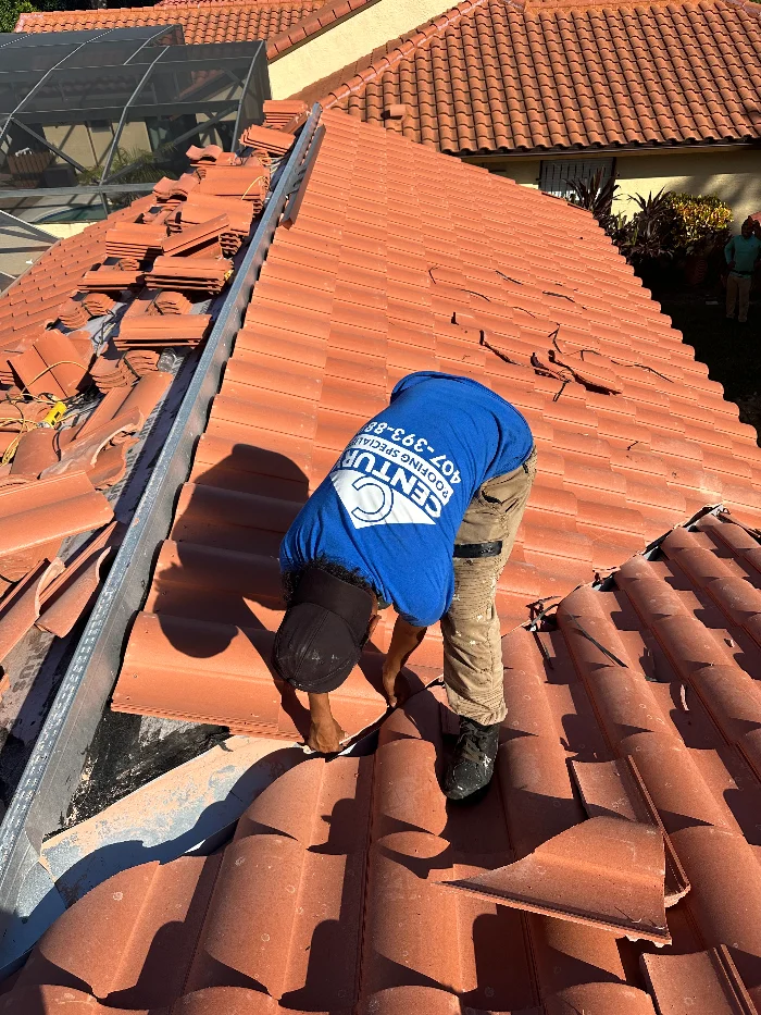 Century Roofing Specialist working on a tile roof
